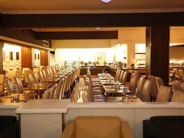 Buffet restaurant dining area, contemporary design for events, spacious and inviting atmosphere.