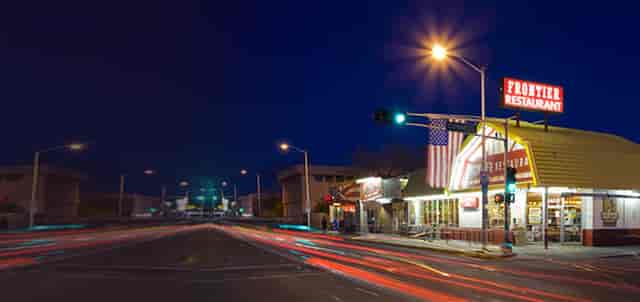 Illuminated restaurant exterior, perfect for casual dinners and networking events at dusk.