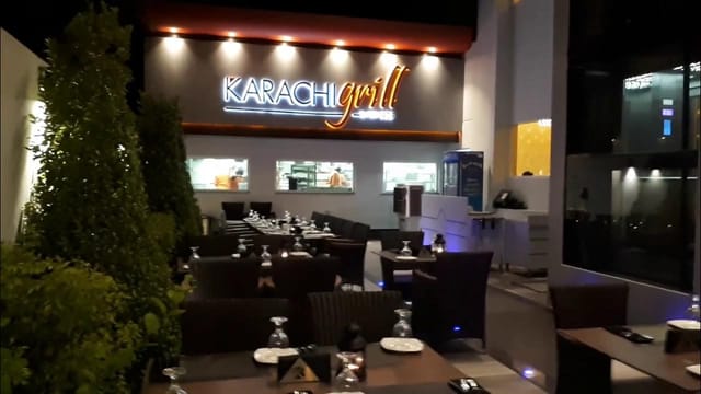 Outdoor dining at Karachi Grill with elegant tables and greenery for events.