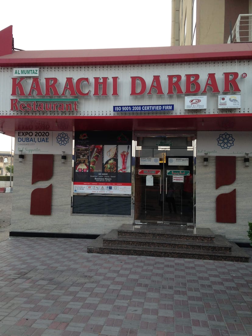 Karachi Darbar Restaurant entrance with vibrant branding, ideal for culinary events and gatherings.