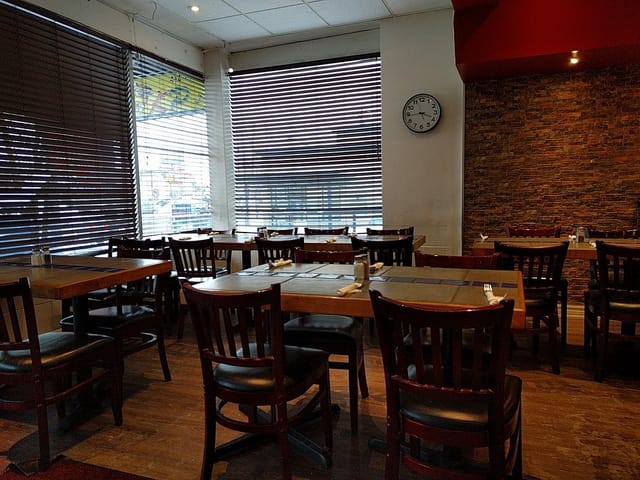Inviting restaurant space at Karahi Point with wooden tables for casual gatherings.