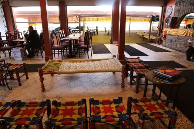 Spacious banquet hall with colorful seating at Lahore Tikka House for casual networking events.