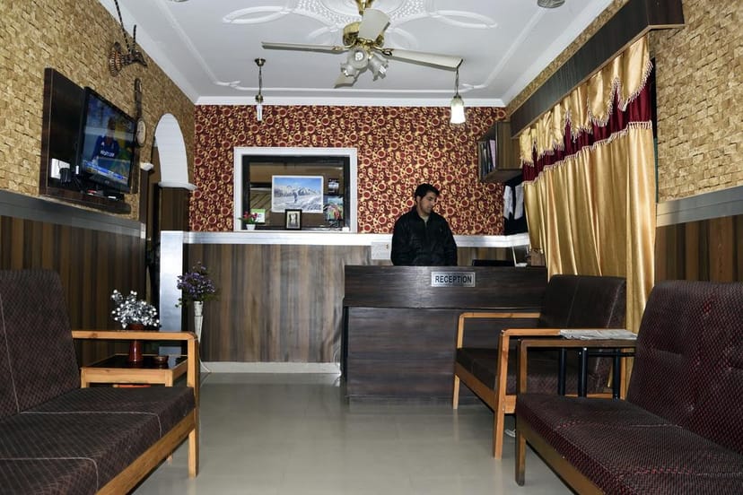 "Hotel Kashmir Inn reception area with plush seating, perfect for events and meetings."