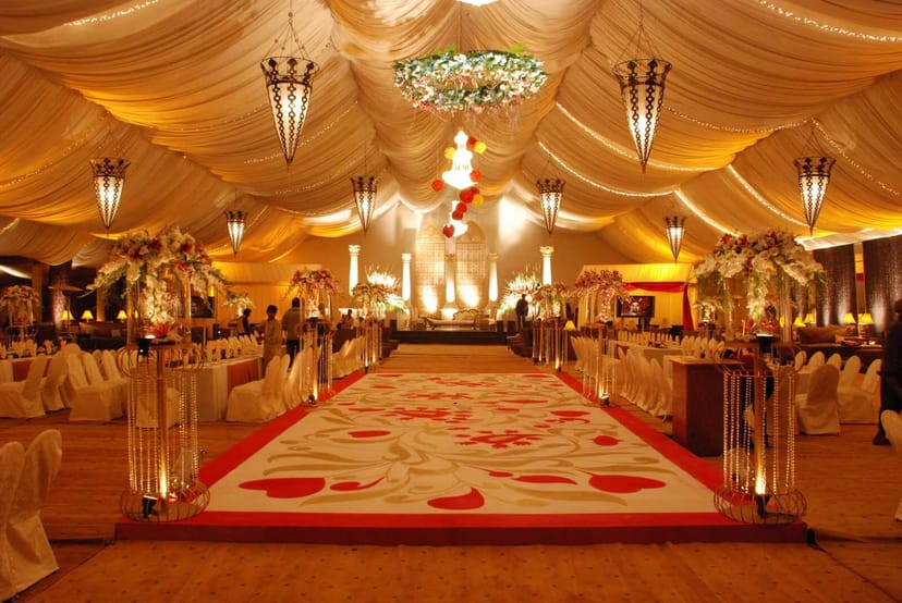 Elegant banquet hall with floral aisle runner, ideal for weddings and gala events.
