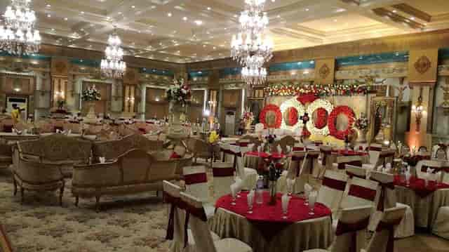 Elegant banquet hall with ornate chandeliers for weddings and corporate events.
