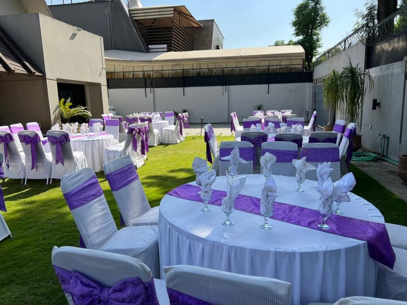 Elegant outdoor event space with purple decor for catering and weddings.