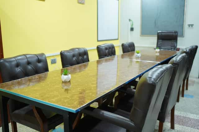 Noble CoSpace meeting room with polished table, perfect for professional events.