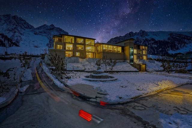 Super Delight venue in Snowland Resorts: modern architecture under a starry sky for winter events.