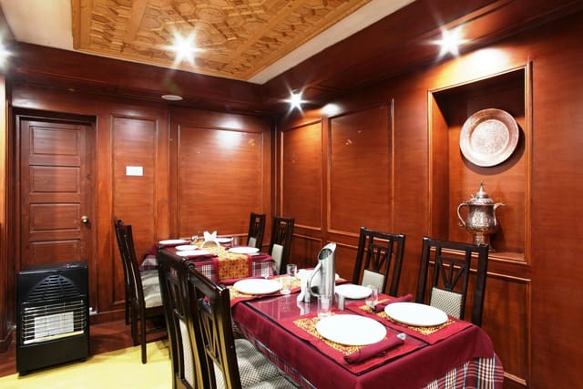 "Intimate vegetarian restaurant meeting space with wooden decor for gatherings and workshops."