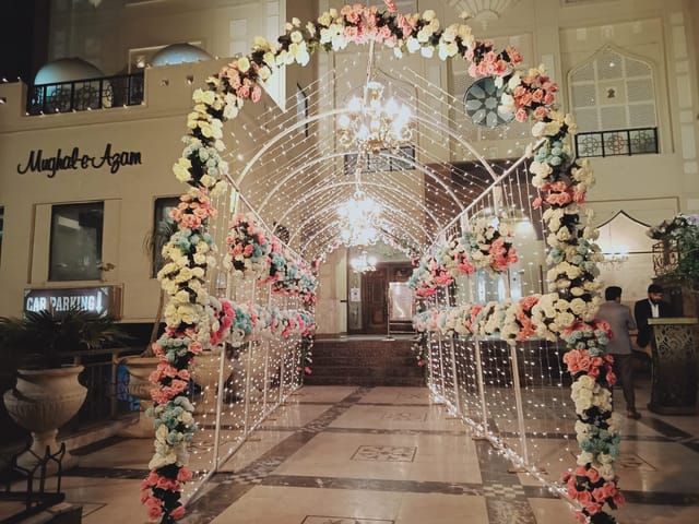 Mannsiraj Hall entrance with floral arch, ideal for weddings and upscale events.