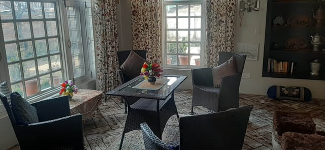Cozy meeting space with wicker chairs and natural light at OYO Home Mountain Breeze Inn.