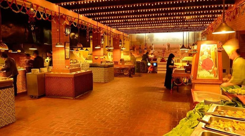 Salt'n Pepper Restaurant event space, warm lighting, buffet gathering ambiance