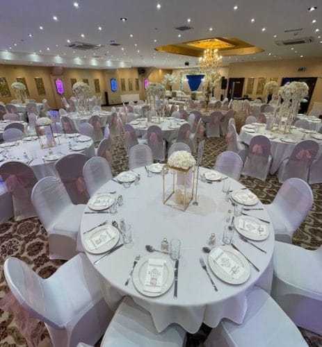 Elegant wedding banquet hall with floral centerpieces in Royal Mahal Event Spaces.