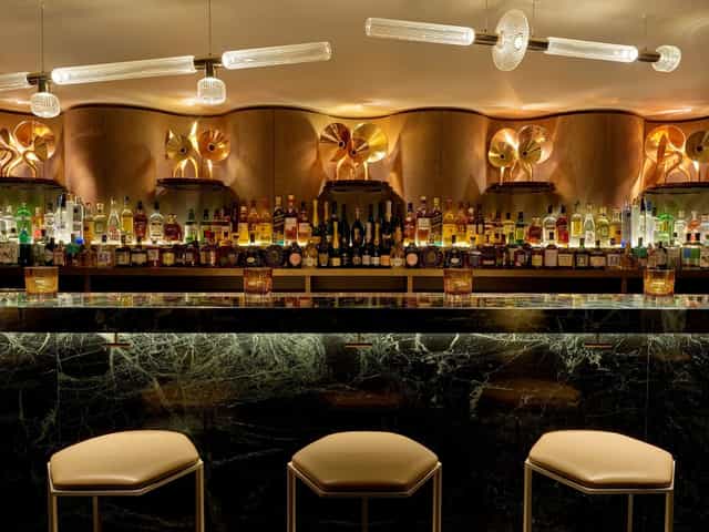 Elegant bar with marble countertop at Royal Mahal for networking and receptions.