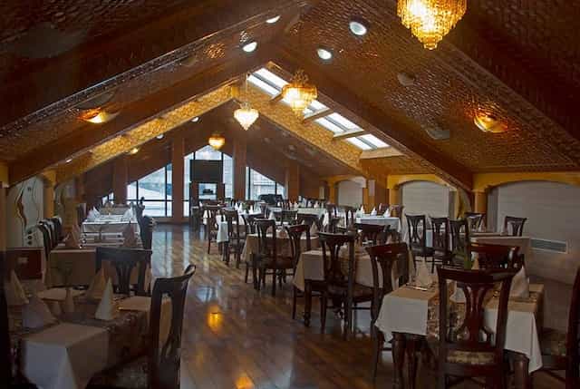Elegant banquet room with ornate ceiling, perfect for corporate events and intimate gatherings.