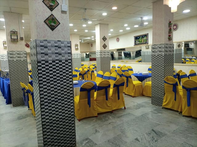 Spacious Musa Banquet Hall with blue and yellow decor for events and celebrations.