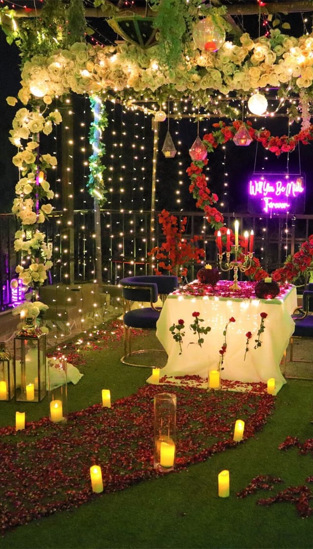 Elegant table with roses and candles for romantic weddings and anniversaries.
