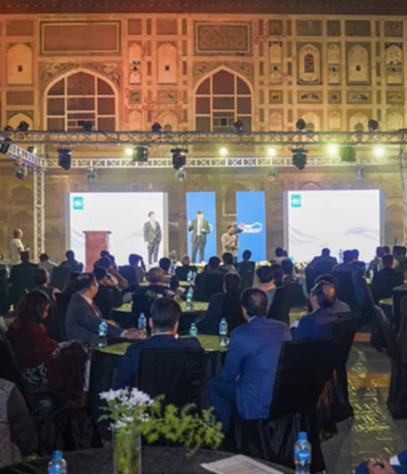 Corporate event at Bastion Café Lahore Fort with presenters engaging an attentive audience.