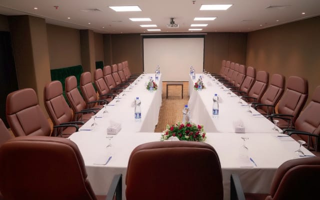 Indigo Hotel Conference Hall with elegant table setup for corporate meetings and seminars.