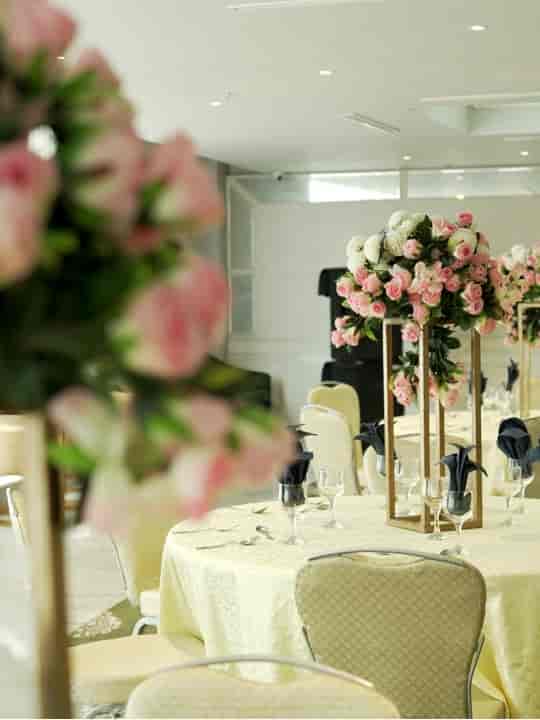 Elegant Conference Hall with pink rose centerpieces for weddings and upscale events.