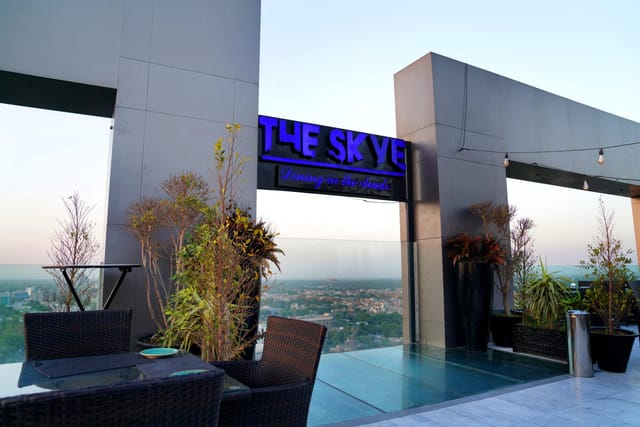 Sophisticated rooftop meeting room "The Skye" at Indigo Hotel with city skyline for events.