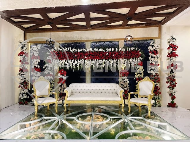 Elegant wedding hall at Indigo Hotel with gold accents and floral decor. Perfect for upscale events.