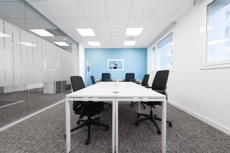 Modern Regus office meeting room with large windows, ideal for collaborative discussions.