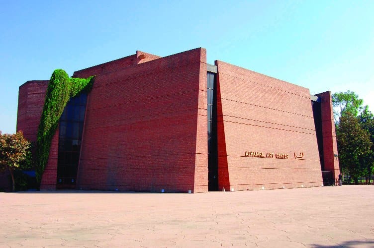 Modern Lahore Arts Council theater with angular brick facade, perfect for events and workshops.