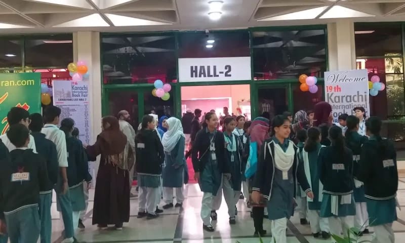 Lahore International Book Fair Hall No.1 entrance with high foot traffic, colorful balloons, networking event.