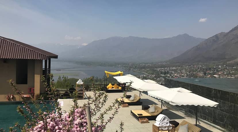 Elegant outdoor dining area at Taj Dal View, Srinagar with stunning lake view for events.