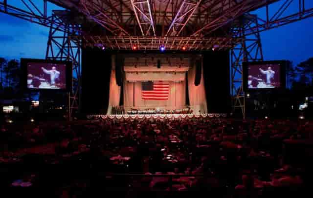 Ameris Bank Amphitheater stage with American flag, perfect for outdoor events and celebrations.