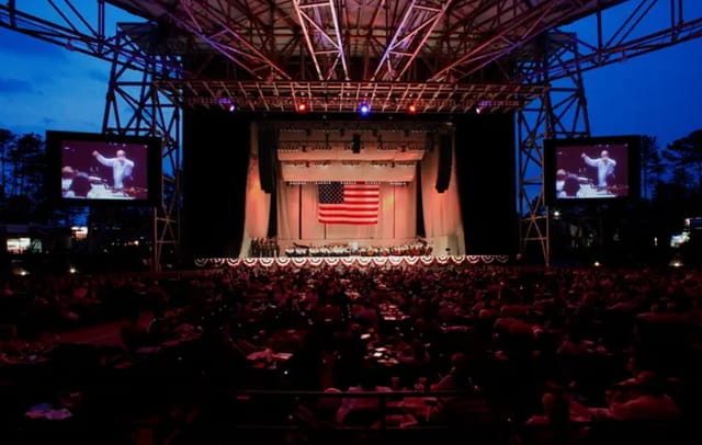 Ameris Bank Amphitheater stage with American flag, perfect for outdoor events and celebrations.
