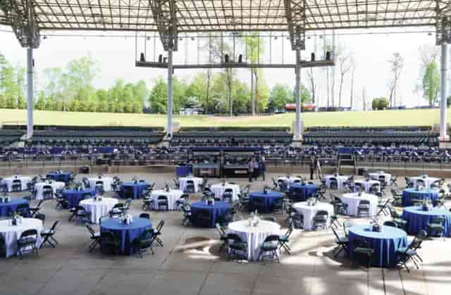 Amphitheatre at Ameris Bank set up for corporate event with blue and white table linens.