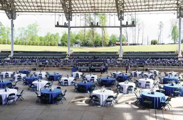 Amphitheatre at Ameris Bank set up for corporate event with blue and white table linens.