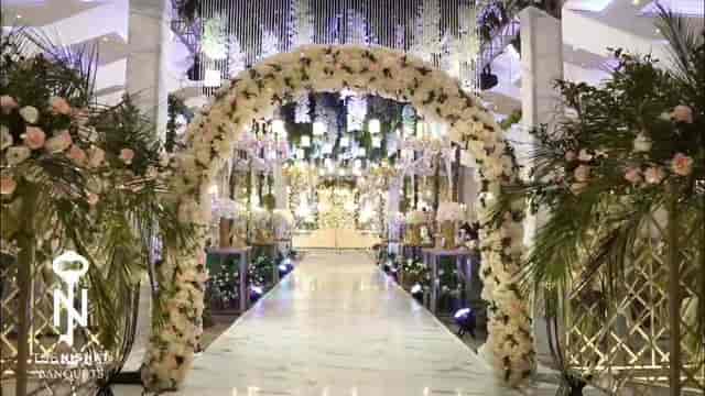 Romantic banquet hall with floral arch, perfect for weddings and upscale events.