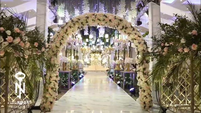 Romantic banquet hall with floral arch, perfect for weddings and upscale events.