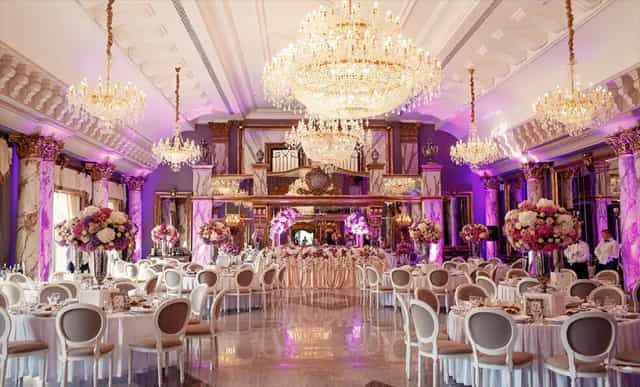 Elegant wedding hall with opulent chandeliers and romantic lighting at Hamara Venue.