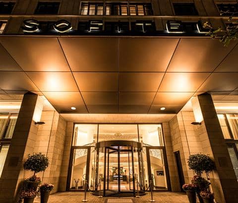 Luxury hotel entrance with revolving door, perfect for upscale events in Frankfurt.