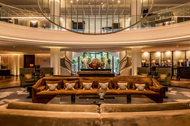 Sophisticated Sofitel Frankfurt lobby with plush seating for corporate meetings and events.
