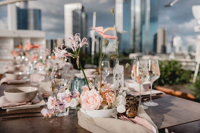 Elegant outdoor dining setup with floral centerpieces at Sofitel Frankfurt Opera.
