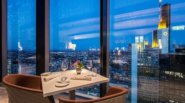 Elegant dining setup with city view at Main Tower Restaurant & Lounge for corporate events.