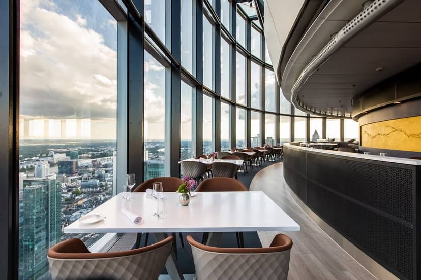 Modern restaurant with panoramic city views, ideal for corporate events and dining.