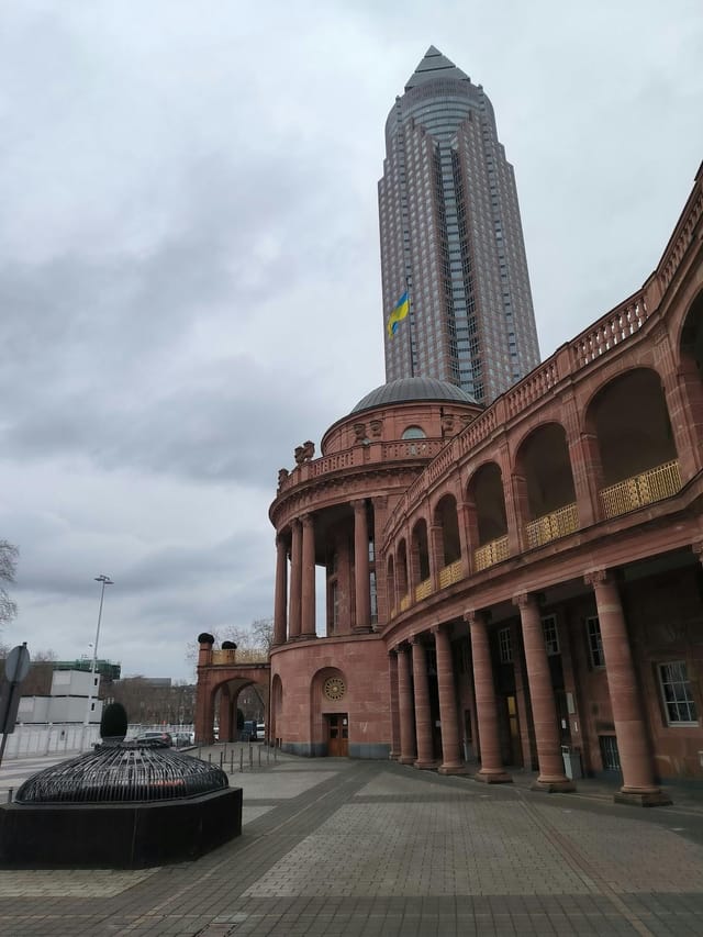 Historic Messe Frankfurt with grand colonnade, ideal for elegant outdoor events.