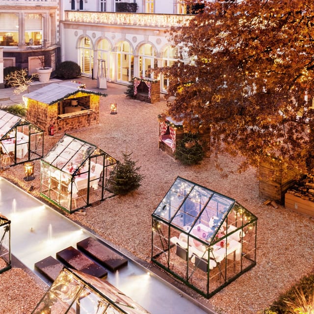 Outdoor event space at Kennedy's Restaurant with festive glass greenhouses, ideal for winter markets.