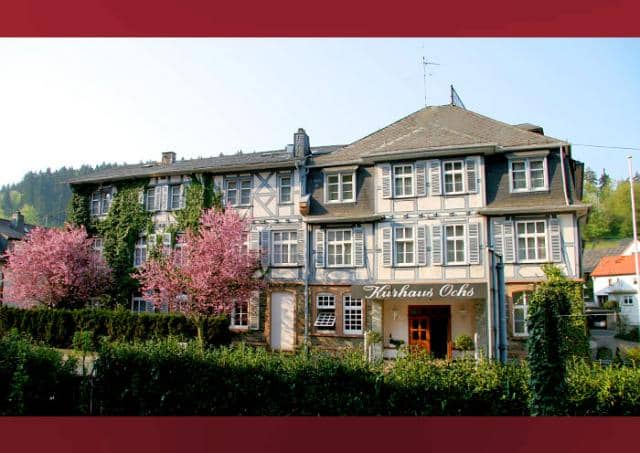 Charming Bistro at Hotel Kurhaus Ochs, ideal for events and retreats with cherry trees.