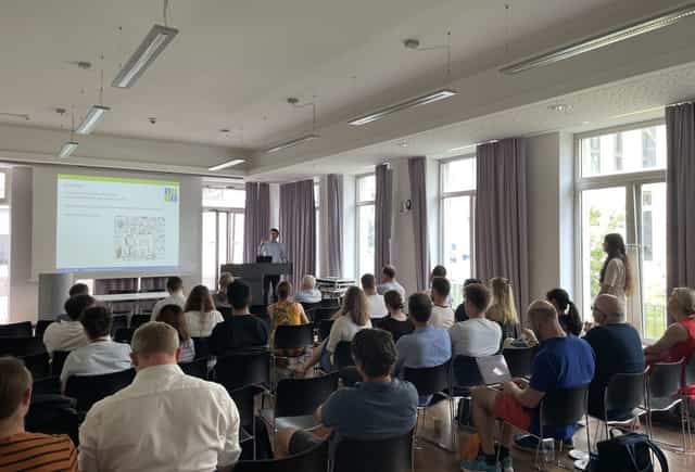 Goethe University Frankfurt seminar room with engaged audience at a professional presentation.