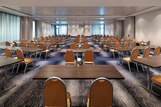 Spacious Sheraton Frankfurt meeting room set up for conferences with natural light.
