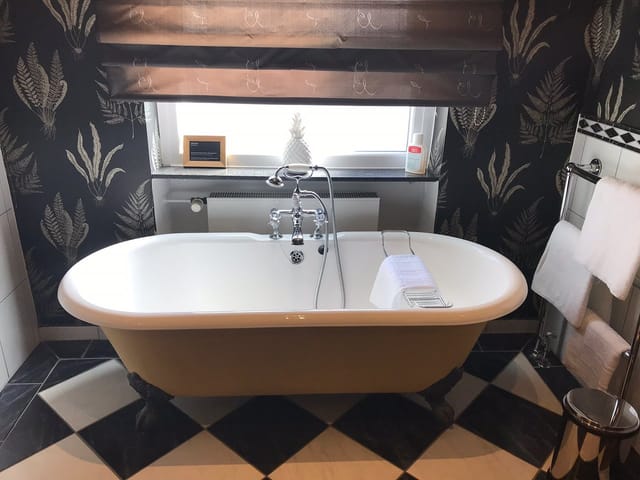 Luxurious freestanding bathtub in Villa Orange lobby, ideal for upscale wellness retreats.