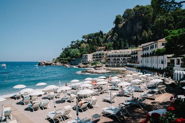Seaside venue at Villa Sant'Andrea for corporate retreats and events, featuring lounge chairs.