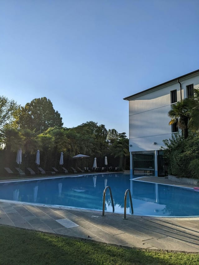 Serene poolside setting at Villa Pace Park Hotel, ideal for outdoor events and meetings.